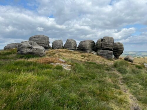 A row of weathered rock formations on Bridestones Moor above Todmorden