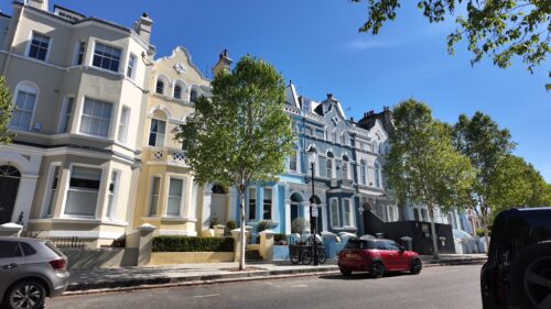 Pastel houses on a Notting Hill filming location street in London